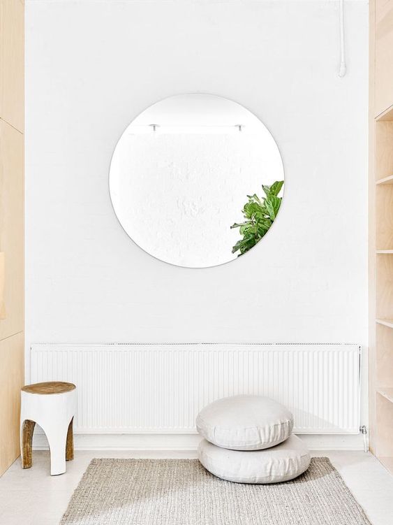 A-minimalist-yoga-space-with-a-mat-cushions-and-a-stool-you-wont-need-more