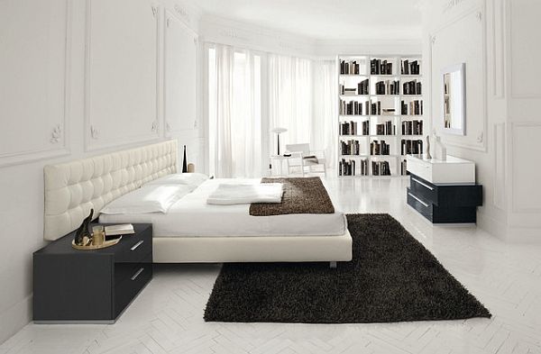 Sleek-white-bedroom-with-dark-colored-rug-for-contrast