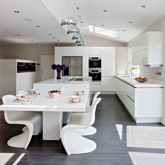 15-ultra-modern-white-kitchen-and-a-corresponding-dining-space-with-sculptrual-chairs