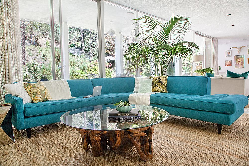 Midcentury-family-room-with-striking-couch-in-turquoise-and-a-cool-coffee-table