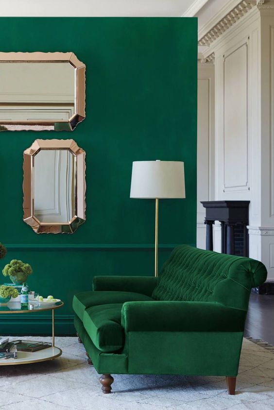 A-bold-living-room-with-an-emerald-wall-a-grene-velvet-sofa-and-touches-of-gold-and-copper-for-more-chic