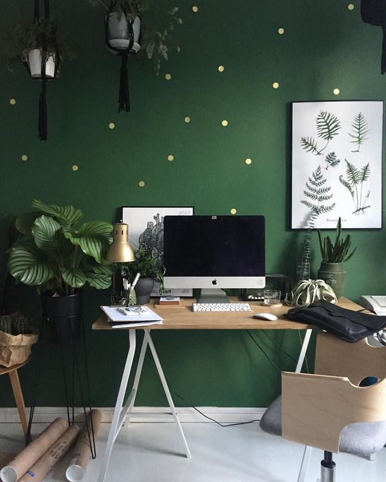 A-bright-green-home-office-with-a-polka-dot-accent-wall-stylish-wooden-furniture-potted-plants-here-and-there