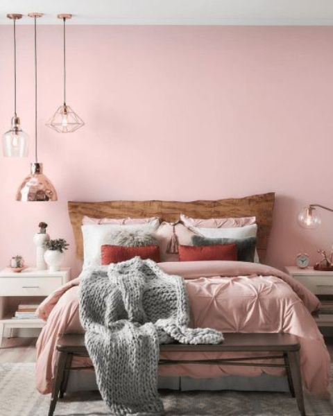 A-chic-contemporary-bedroom-with-a-pink-statement-wall-pink-bedding-grey-touches-pendant-lamps-and-white-furniture