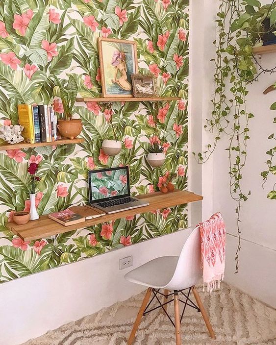 A-colorful-tropical-home-office-nook-with-a-tropical-accent-wall-a-floating-desk-and-shelves-and-potted-plants