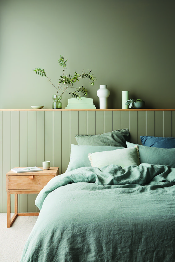 A-monochromatic-green-bedroom-with-matte-walls-and-beadboards-green-bedding-and-touches-of-natural-wood