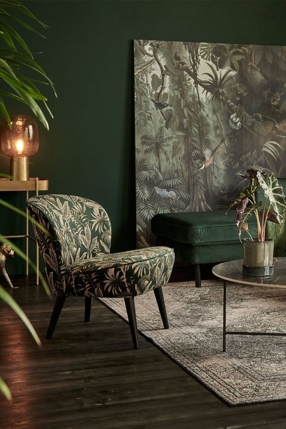A-moody-refined-living-room-with-hunter-green-walls-a-matching-upholstered-bench-a-moody-artwork-and-a-chair-plus-touches-of-gold
