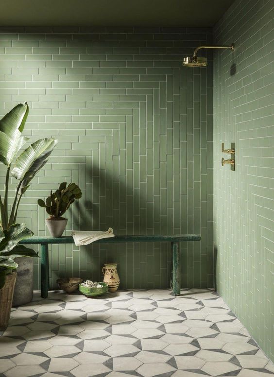 A-natural-green-bathroom-with-long-tiles-in-a-pretty-pattern-a-green-bench-and-lots-of-potted-plants