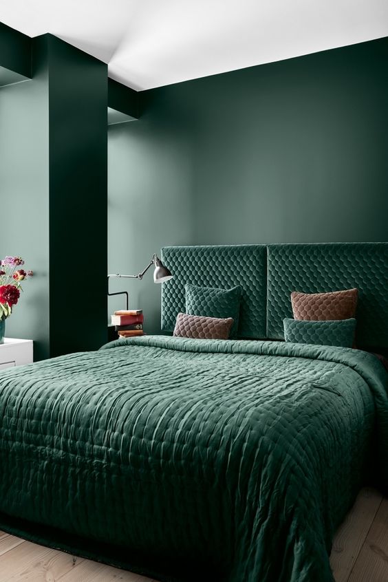 A-refined-bedroom-with-matte-hunter-green-walls-a-matchin-velvet-upholstered-bed-and-bedding-plus-much-natural-light