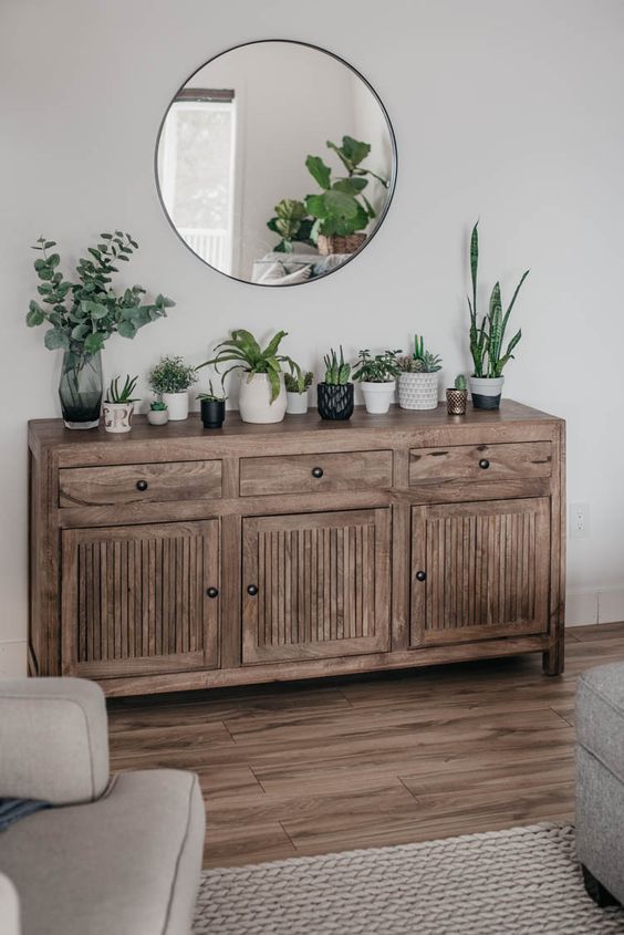A-rustic-wooden-console-with-lots-of-potted-plants-and-greenery-is-a-pretty-idea-to-bring-a-spring-feel-to-the-space