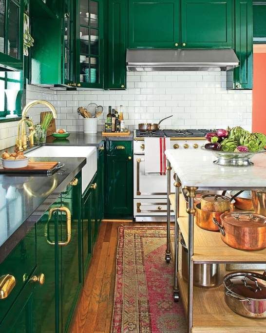A-shiny-glam-emerald-kitchen-a-white-subway-tile-backsplash-black-countertops-and-gold-and-brass-touches