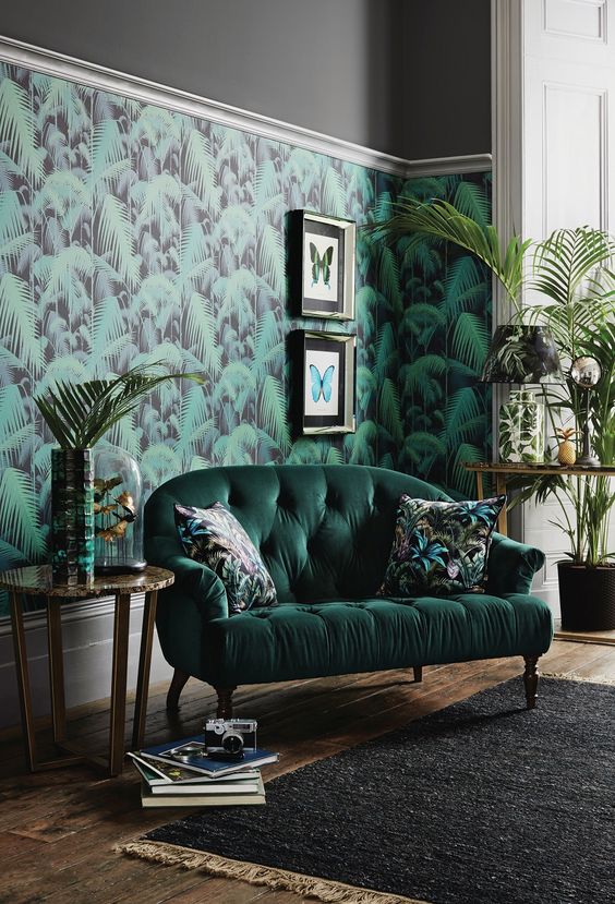 A-stylish-living-room-with-a-tropical-leaf-wall-a-hunter-green-sofa-potted-greenery-and-artworks
