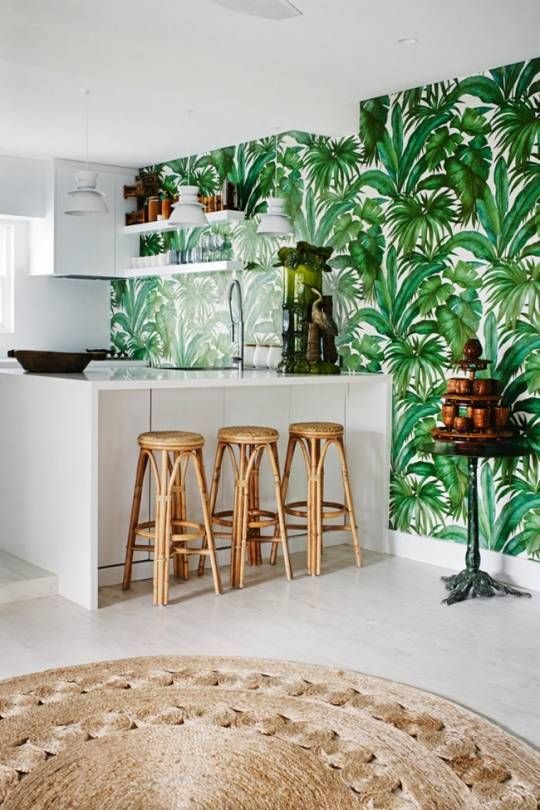 A-stylish-tropical-kitchen-with-a-tropical-leaf-wall-sleek-white-cabinets-rattan-stools-and-a-jute-rugs-reminds-of-beaches