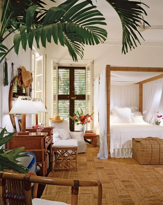 A-tropical-bedroom-with-a-jute-rug-a-bamboo-bed-with-a-canopy-wooden-furniture-and-shutters-plus-tropical-plants