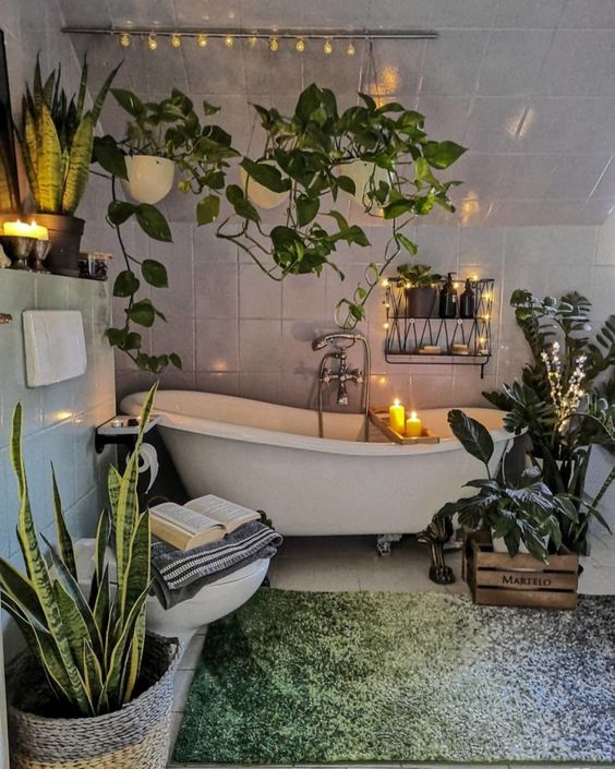 An-urban-jungle-bathroom-with-climbing-plants-potted-statement-ones-a-clawfoot-tub-and-a-green-rug