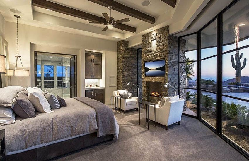 Contemporary-bedroom-with-stone-fireplace-and-sitting-area