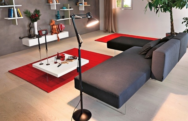 Contemporary-gray-sofa-red-area-rugs-white-wall-shelves-cofee-table