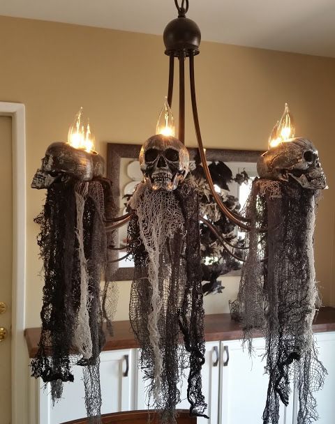Elegant-and-scary-halloween-decor-a-chandelier-with-skulls-and-black-fabric-down-is-a-fantastic-idea