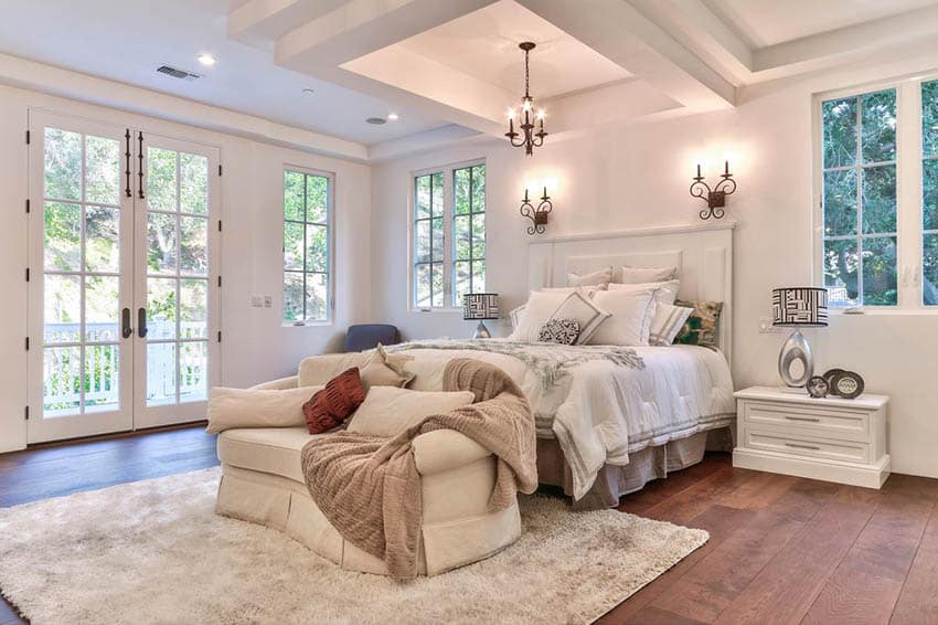 Master-bedroom-with-french-doors-plush-loveseat-and-engineered-acacia-flooring