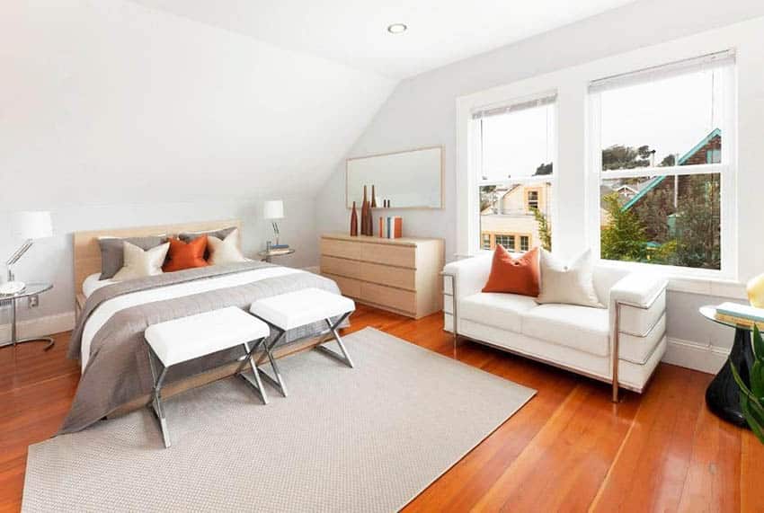 Modern-bedroom-with-cinnamon-maple-hardwood-floor-white-sofa-under-window