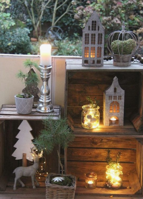 Pretty-winter-balcony-decor-with-crates-candle-lanterns-moss-and-evergreens-deer-and-plywood-trees