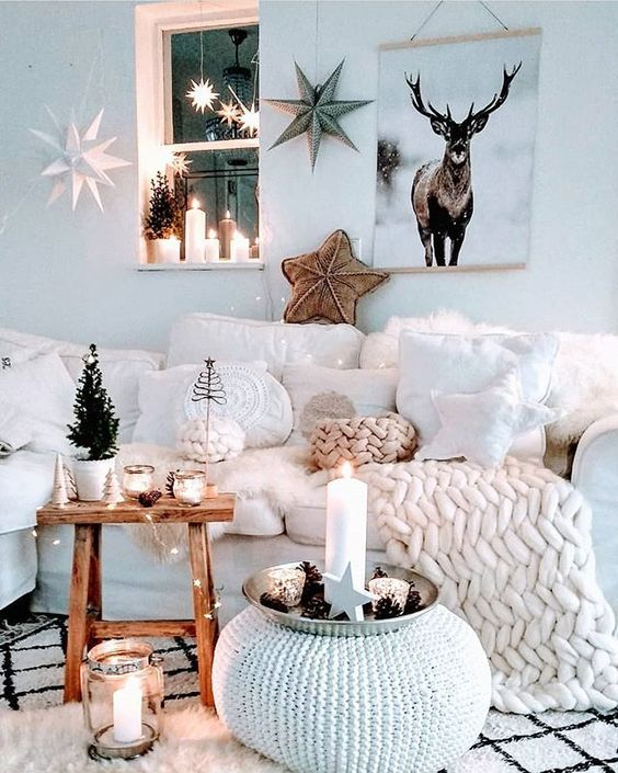 24-an-amazing-winter-wonderland-living-room-with-a-white-sectional-pillows-and-chunky-knit-mini-trees-candles-lots-of-stars-and-lights
