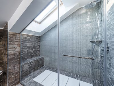 Glass shower cabin in modern loft bathroom