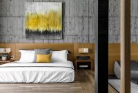 Yellow bedroom in concrete themed home interior
