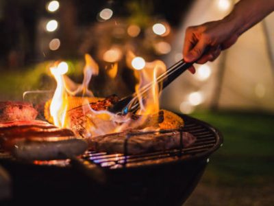 Family making barbecue in dinner party camping at night