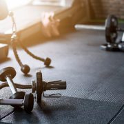Gym background fitness weight equipment on empty dark floor