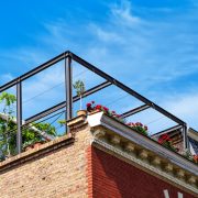 View from below on a outdoor terrace on the roof with plants and flowers