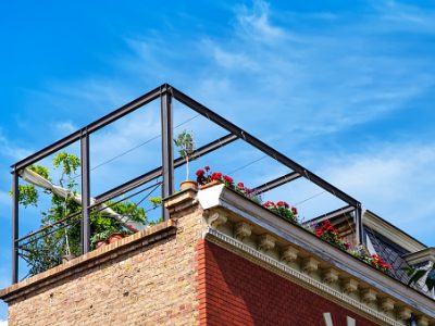 View from below on a outdoor terrace on the roof with plants and flowers