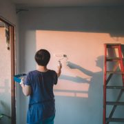An asian chinese mid adult female painting her living room, apartment