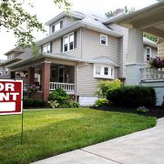 Home for rent sign in front of beautiful american home