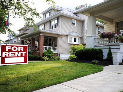 Home for rent sign in front of beautiful american home