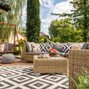 New design villa patio with comfortable rattan furniture and pattern carpet