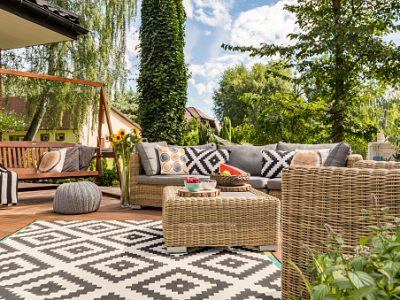 New design villa patio with comfortable rattan furniture and pattern carpet
