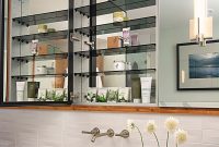 Recessed medicine cabinet behind bathroom mirror