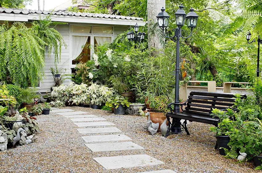 Concrete-stone-walkway-with-gravel-pebble-patio-and-park-bench.jpg