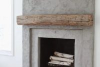 Contemporary concrete fireplace with a rough wood