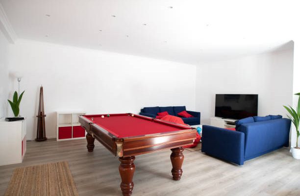 Living room with pool table and blue sofas