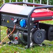 Working portable electric generator on green grass