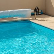 Closeup on a pool cover on the edge of a pool during the summer