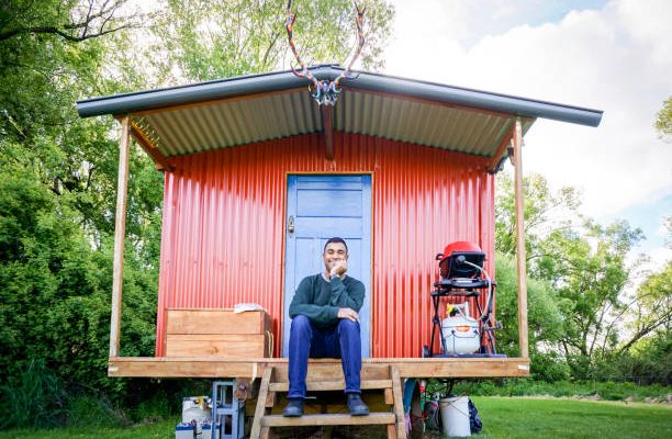 Young tourist traveler sits in front of cabin