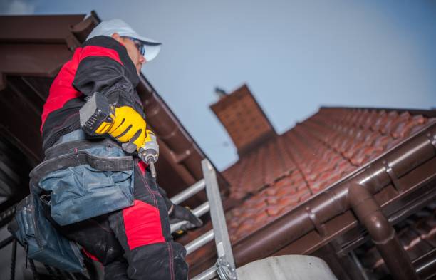 Caucasian roof worker with power tool. residential construction site.