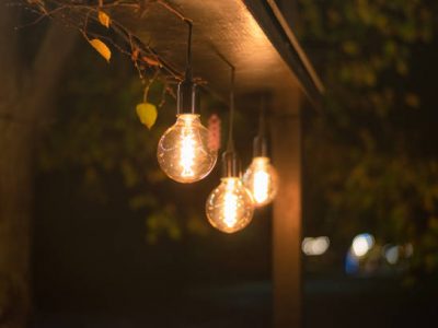 Electric incandescent light bulb street lamps glow brightly in the night park