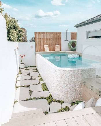 Let the grass peek through the pavers Spectacular Landscaping Ideas To Beautify An Above-Ground Pool