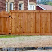 New wooden fence and gate with a professional look of construction