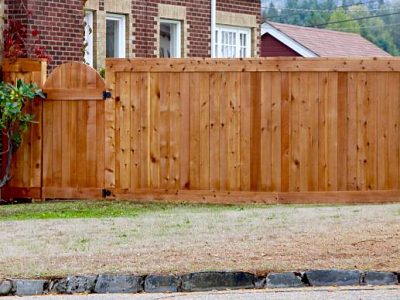New wooden fence and gate with a professional look of construction