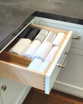 Rolling the kitchen towels Above Brilliant Ways To Organize Your Crowded Kitchen Drawers