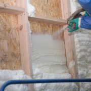 Foam is applied to the walls to warm the house at construction